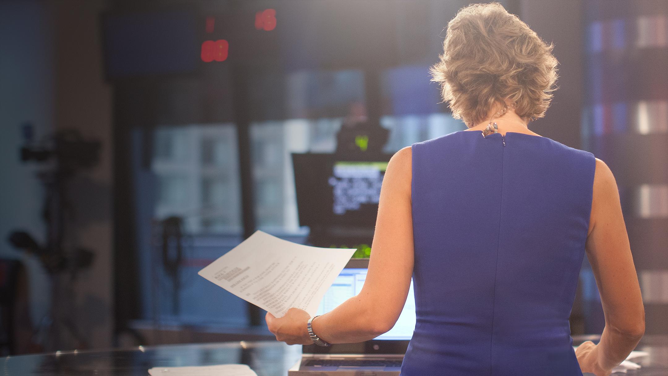 Journalist with back to camera